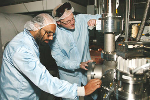 Researchers inspecting equipment
